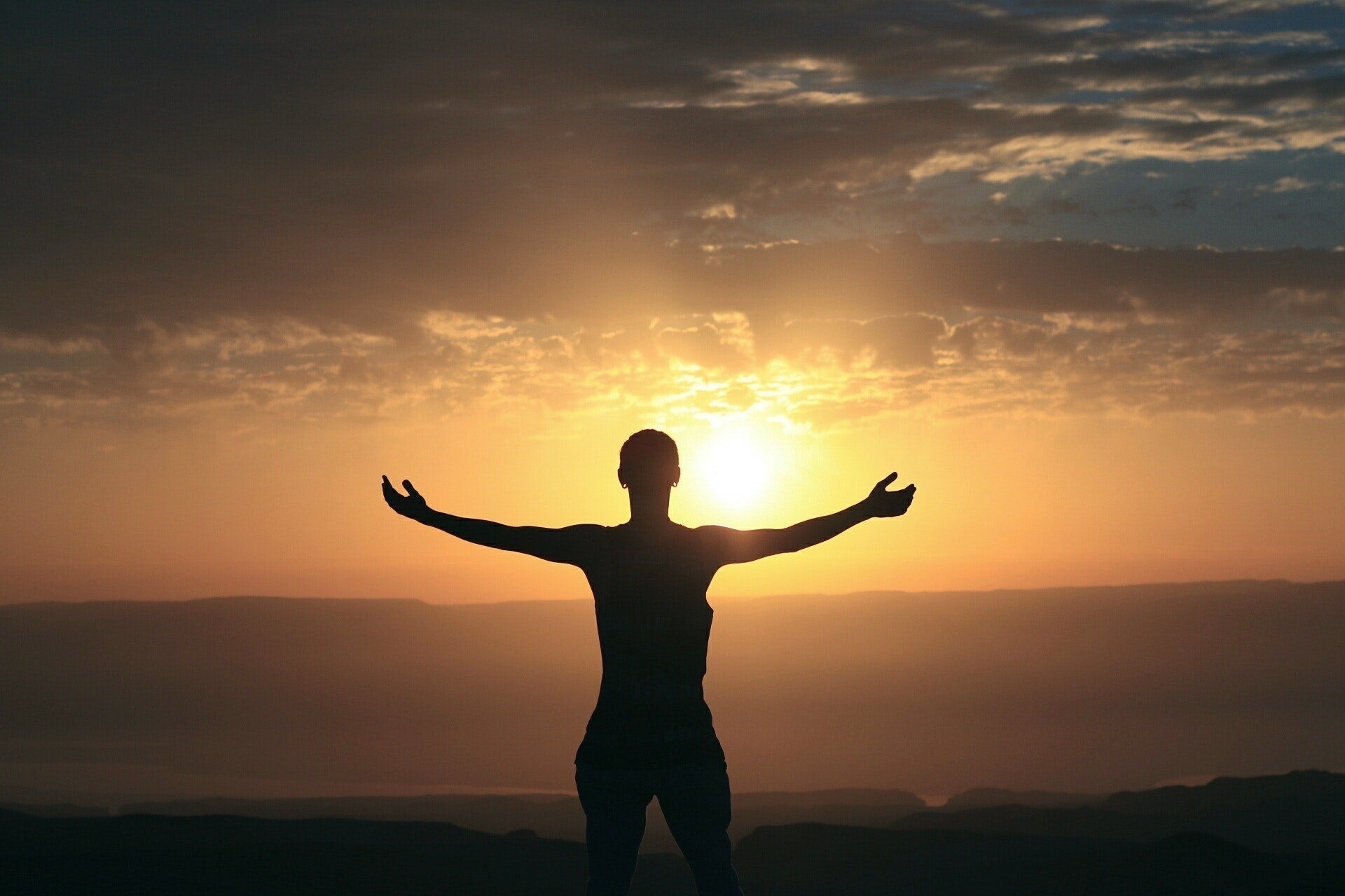 Silhouetted man appreciating the sunset